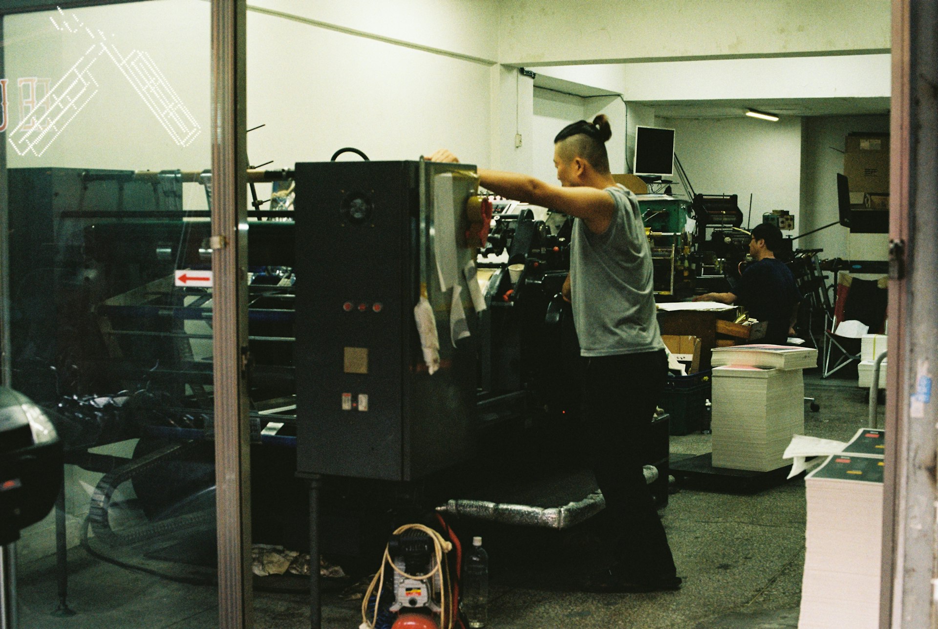 a man standing in front of a machine in a room